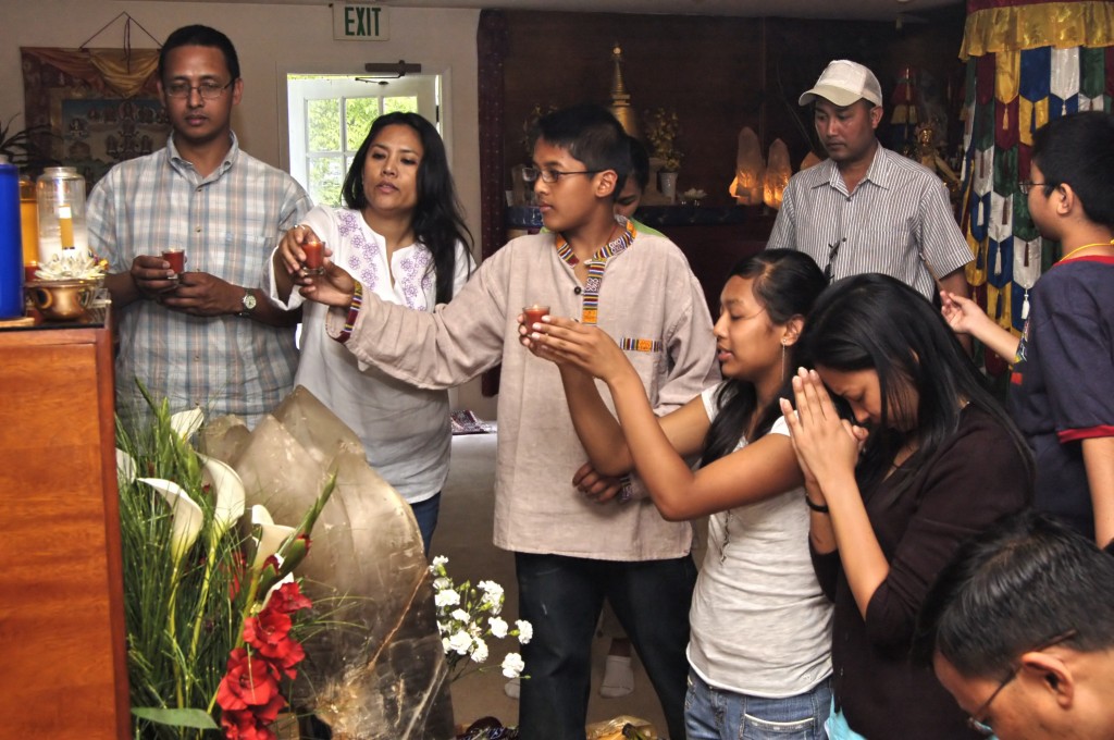 Family making offerings at Kunzang Palyul Choling Temple